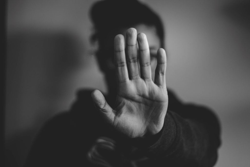 Person showing hand in stop gesture
